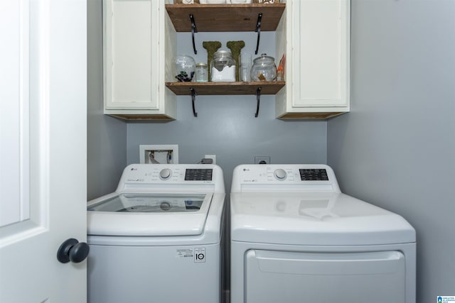 laundry room with cabinet space and washing machine and clothes dryer