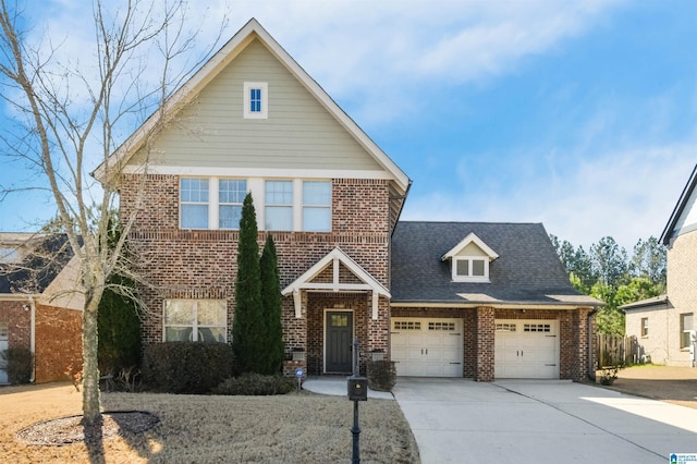 traditional-style house with a garage, brick siding, concrete driveway, and a shingled roof