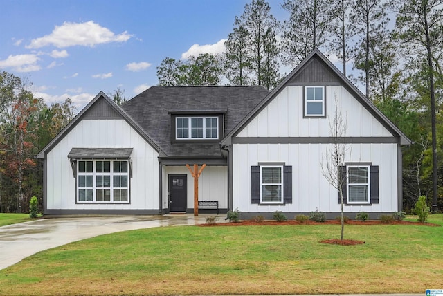 modern farmhouse featuring a front yard, board and batten siding, and a shingled roof