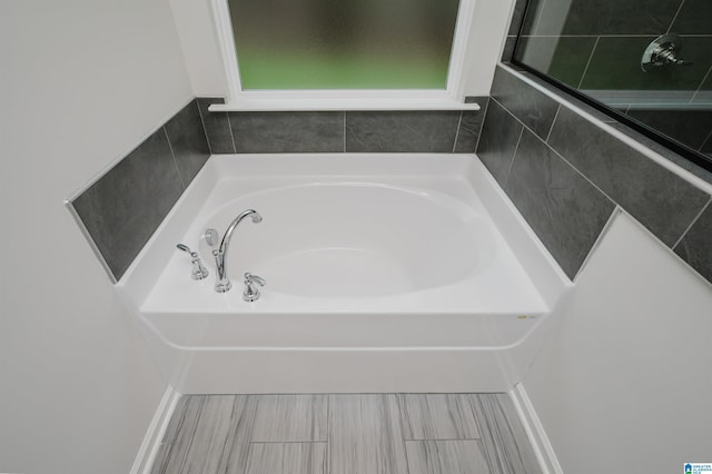 bathroom with a garden tub