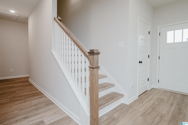 foyer entrance with stairway, recessed lighting, baseboards, and wood finished floors