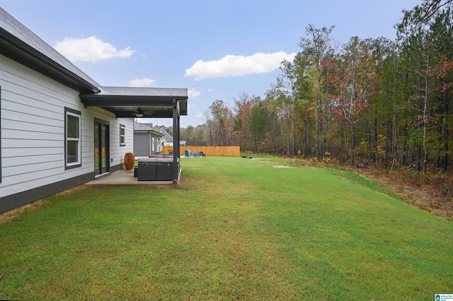 view of yard featuring a ceiling fan and a patio