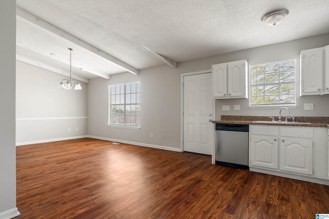 kitchen with dark wood-style flooring, a sink, white cabinets, dishwasher, and dark countertops