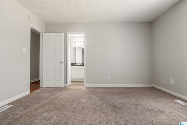 unfurnished bedroom with visible vents, carpet flooring, and baseboards