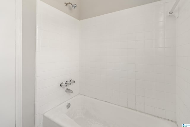 bathroom with bathing tub / shower combination