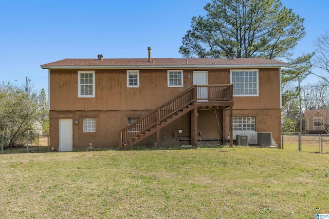 rear view of property featuring a lawn, a gate, fence, stairway, and central AC unit