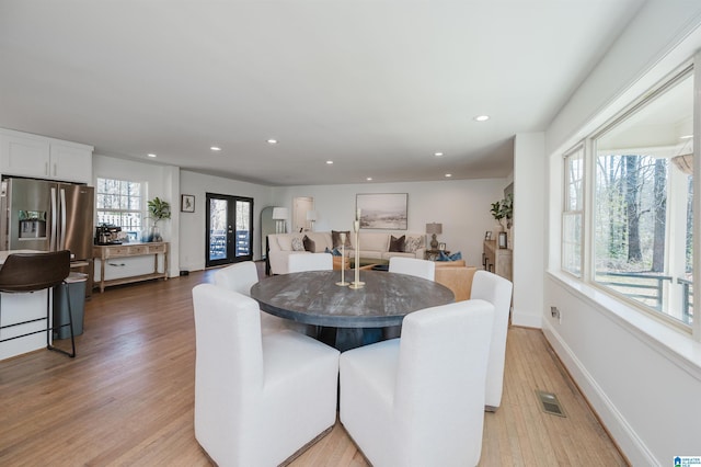 dining area featuring visible vents, recessed lighting, french doors, light wood finished floors, and baseboards