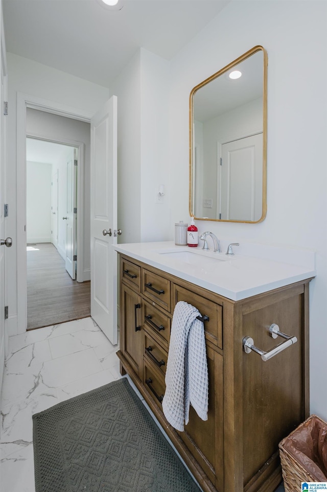 bathroom with marble finish floor and vanity