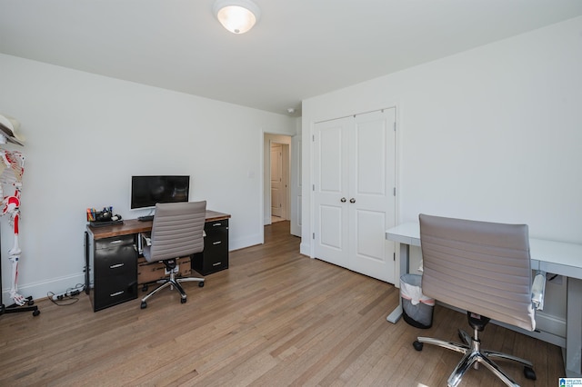 office with baseboards and light wood-style floors