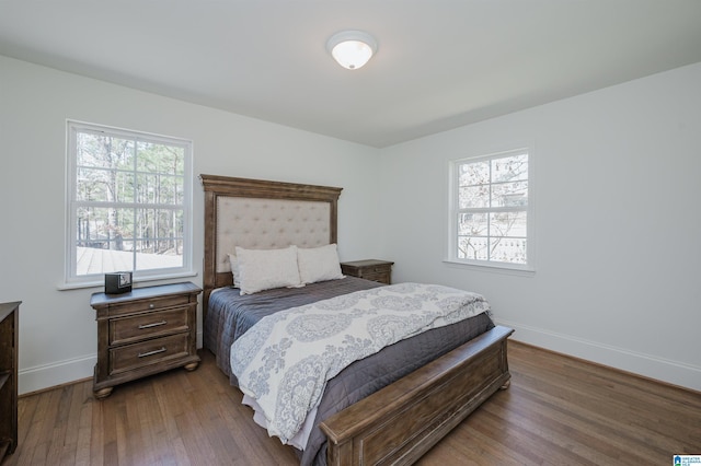 bedroom featuring baseboards and wood-type flooring