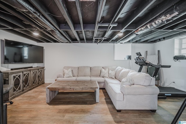 living room with baseboards and wood finished floors