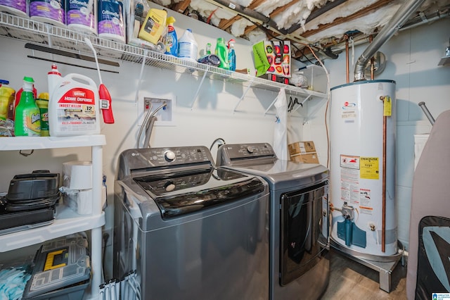 clothes washing area with laundry area, gas water heater, wood finished floors, and separate washer and dryer