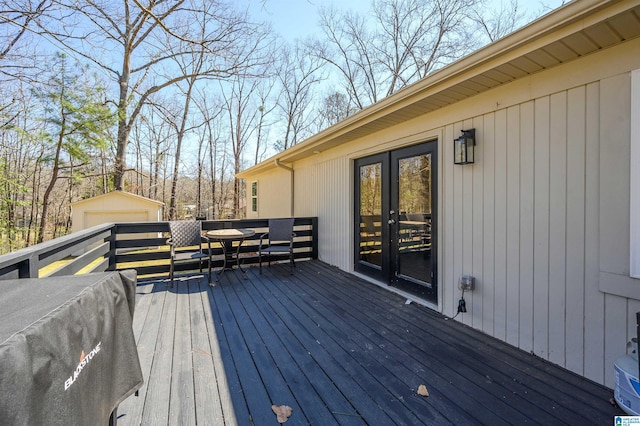 wooden deck featuring french doors and an outdoor structure