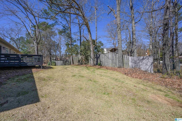 view of yard with a wooden deck and fence private yard