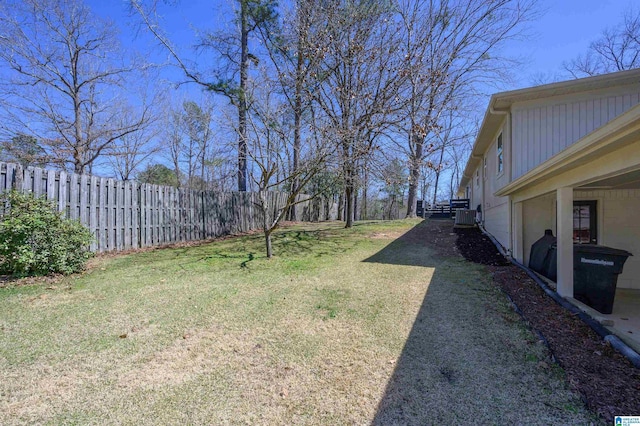 view of yard featuring central air condition unit and fence