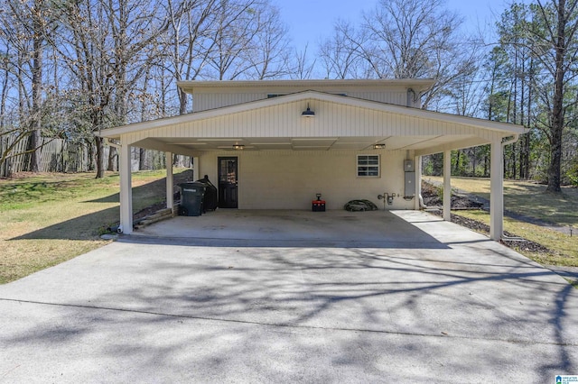 view of side of property featuring an attached carport, driveway, and a yard