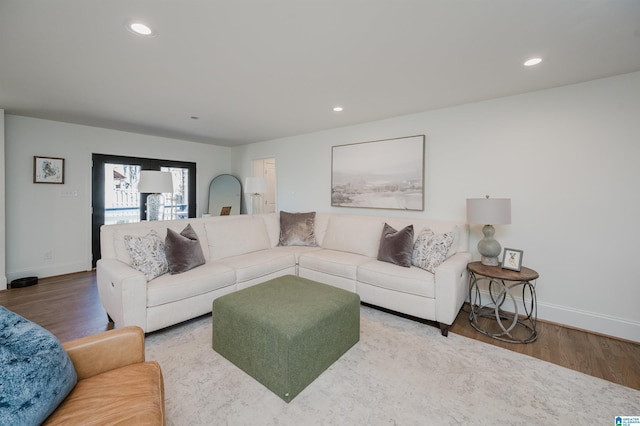 living area featuring recessed lighting, wood finished floors, and baseboards