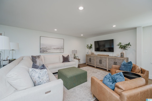 living area featuring recessed lighting, baseboards, and wood finished floors