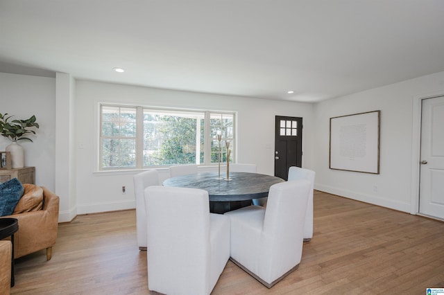 dining room with light wood finished floors, recessed lighting, and baseboards