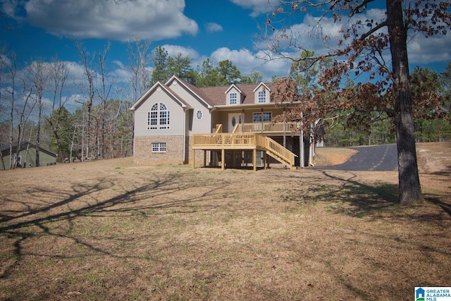 back of property featuring stairway, a lawn, and a porch