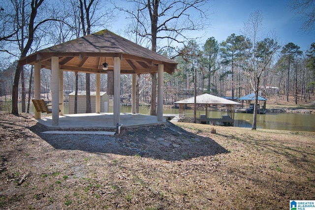 view of yard featuring a gazebo, a patio, and a water view