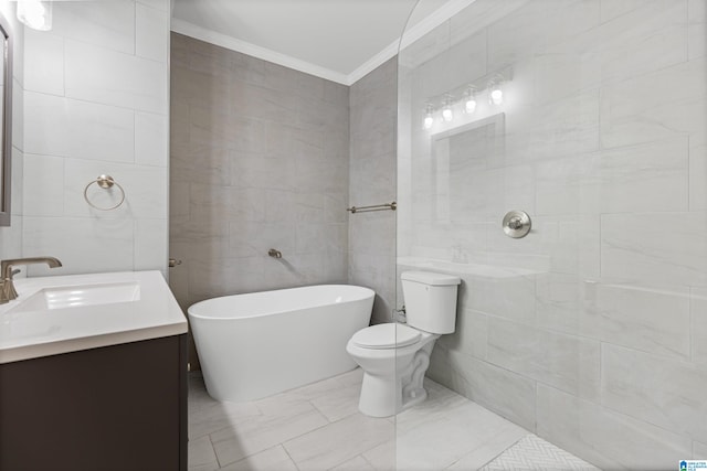 full bath featuring toilet, a freestanding bath, vanity, ornamental molding, and tile walls