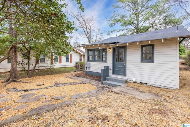 bungalow-style house featuring crawl space, entry steps, and fence