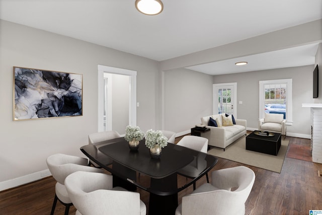 dining space with wood finished floors and baseboards