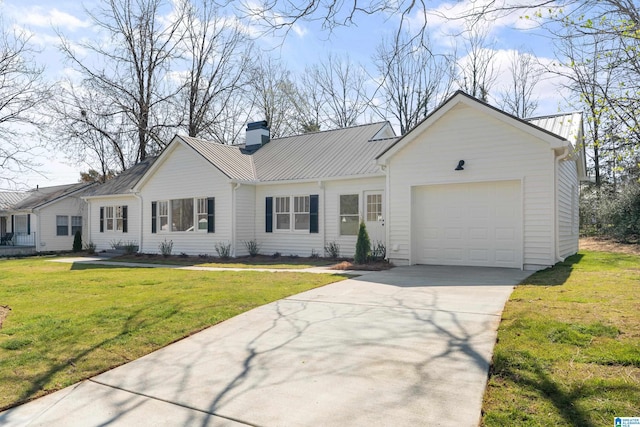 single story home with metal roof, a front lawn, concrete driveway, and an attached garage