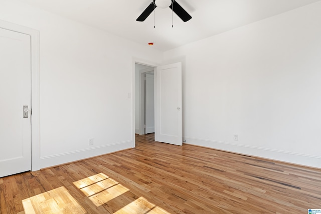 empty room with light wood-style flooring, baseboards, and ceiling fan