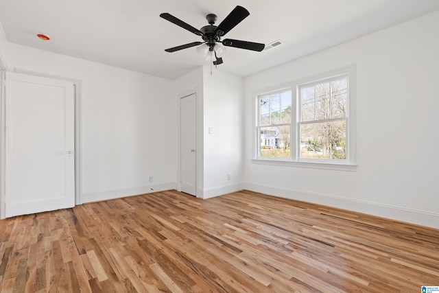 unfurnished bedroom featuring visible vents, baseboards, light wood-style floors, and ceiling fan