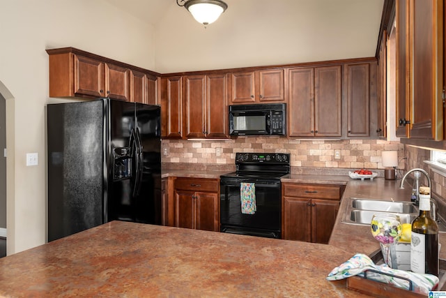 kitchen featuring black appliances, arched walkways, backsplash, and a sink