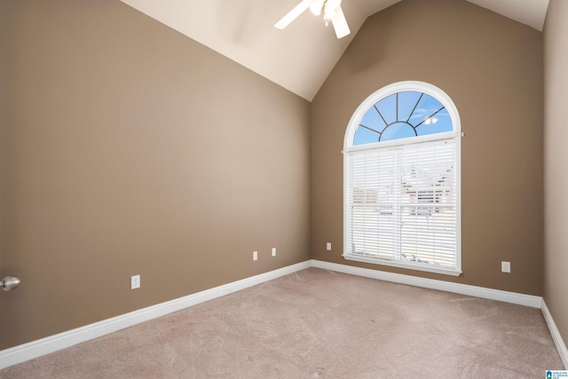 spare room with high vaulted ceiling, a ceiling fan, baseboards, and light carpet