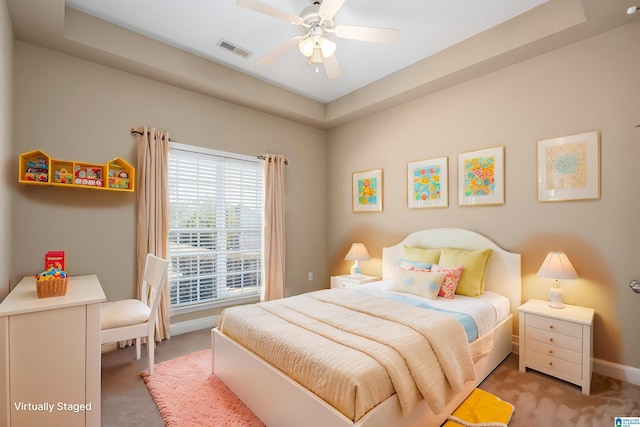 bedroom with a ceiling fan, baseboards, visible vents, and light carpet