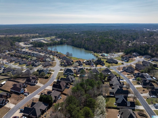 drone / aerial view with a residential view, a forest view, and a water view