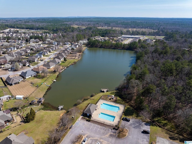 bird's eye view with a forest view and a water view