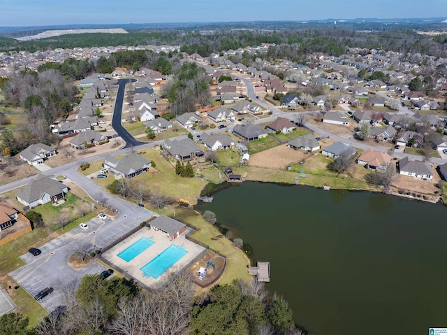 drone / aerial view with a residential view and a water view