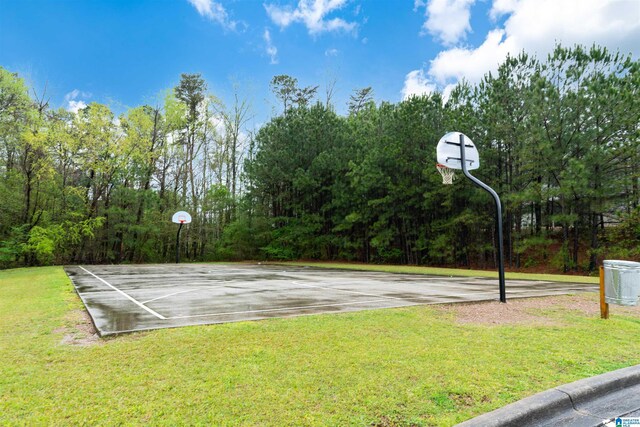 view of sport court featuring community basketball court and a lawn