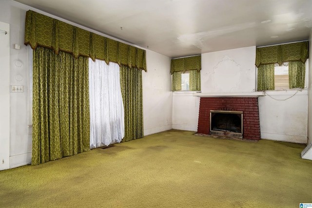 unfurnished living room featuring carpet flooring and a fireplace