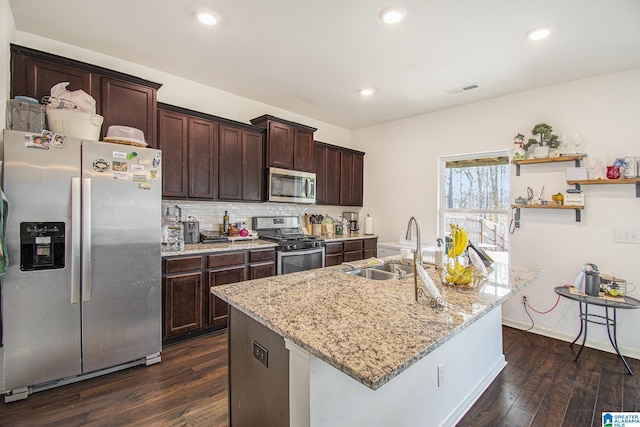 kitchen featuring dark brown cabinets, stainless steel appliances, dark wood-type flooring, and a sink