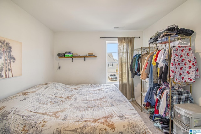 carpeted bedroom featuring visible vents