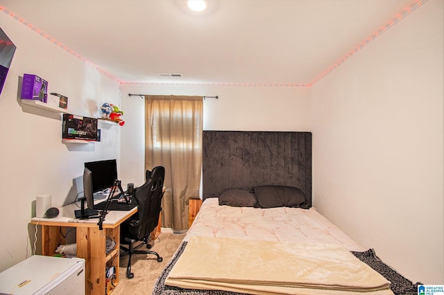 bedroom featuring visible vents and light carpet