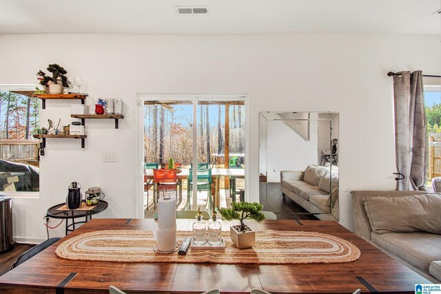 dining room featuring visible vents and dark wood-style flooring