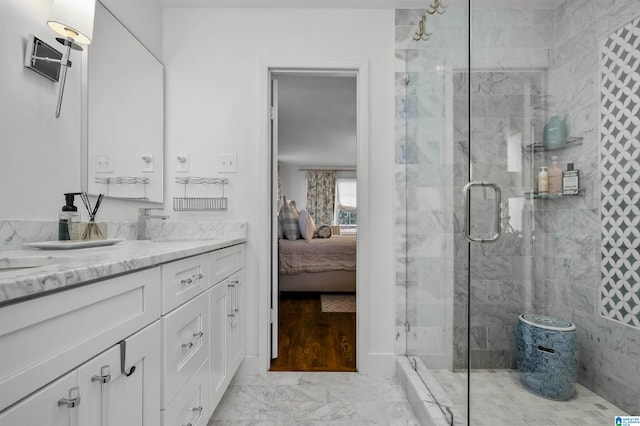 bathroom with vanity, marble finish floor, ensuite bathroom, and tiled shower