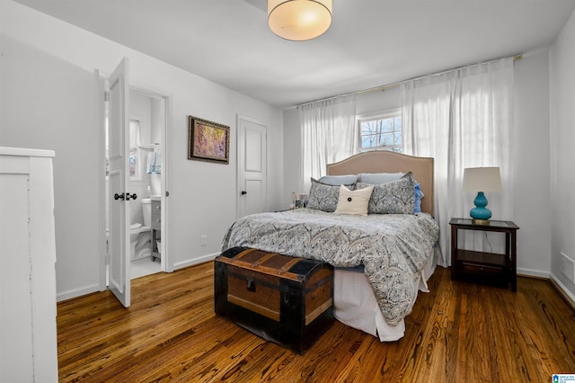 bedroom with wood finished floors and baseboards