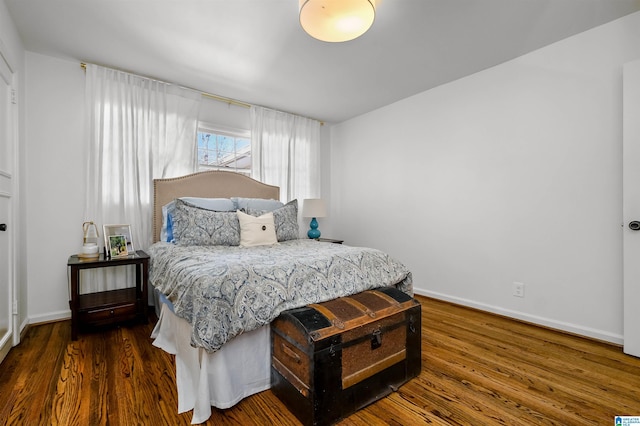 bedroom featuring wood finished floors and baseboards