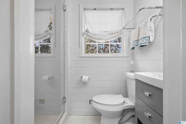 full bathroom with vanity, a shower stall, and toilet