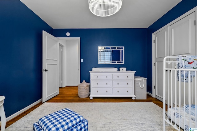 bedroom featuring dark wood finished floors and baseboards