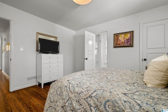 bedroom featuring dark wood-style floors, visible vents, and baseboards