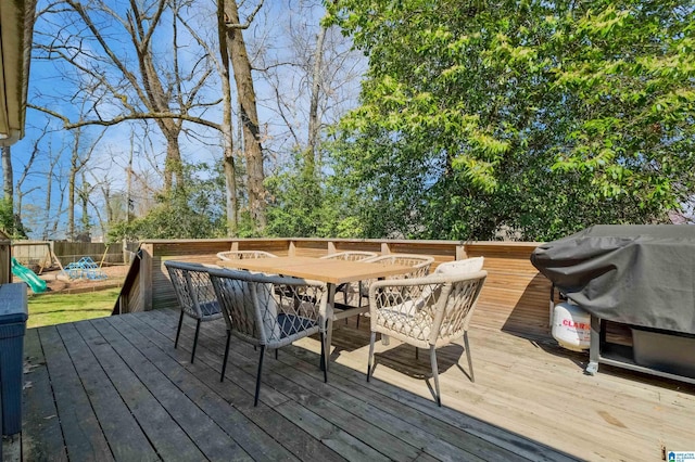 deck with area for grilling, outdoor dining area, and fence